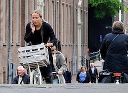 Girl talking on Cell phone on bike